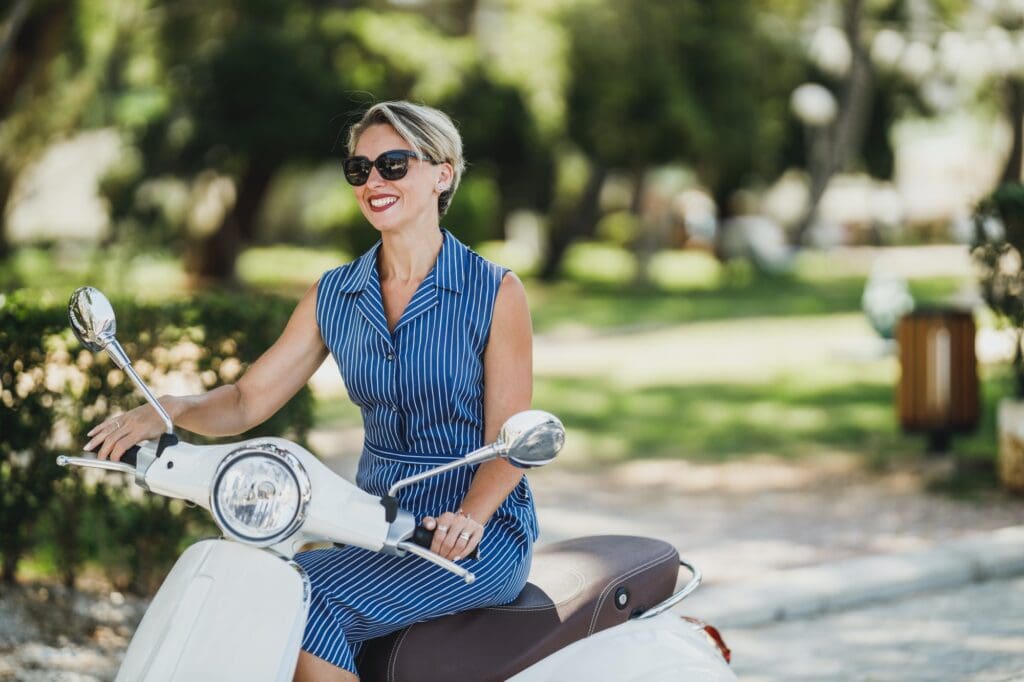 Woman Riding A Vintage Scooter