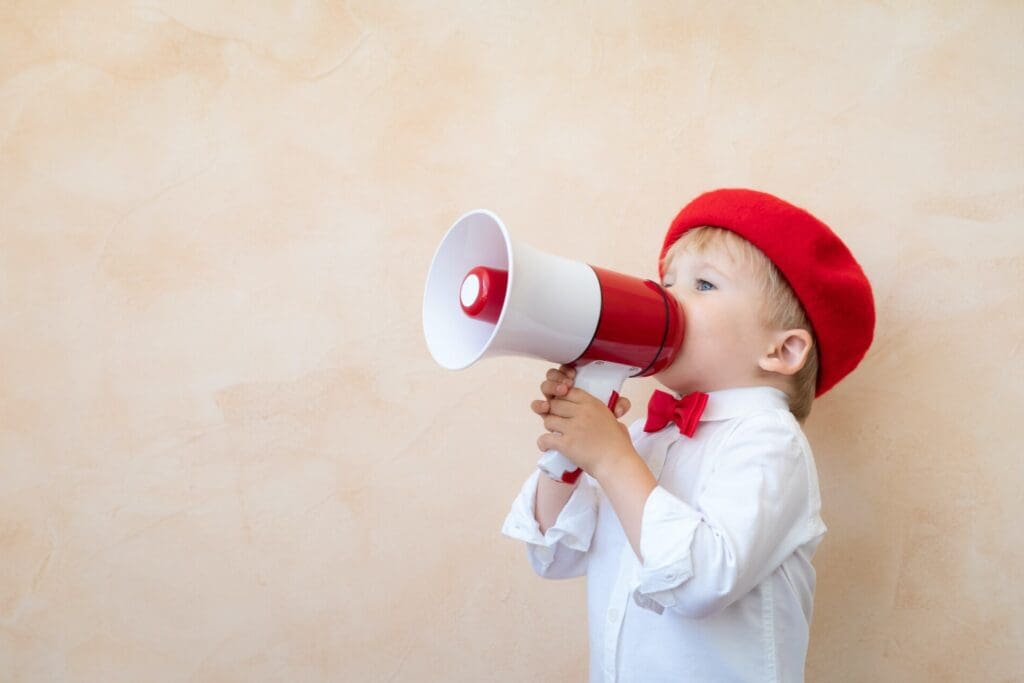 Child shouting through vintage megaphone