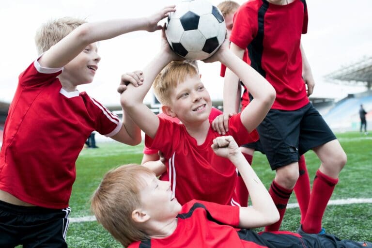 Football Team Cheering Holding Ball