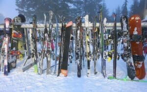 Vivid skiing and snowboarding gear on ski resort close up.