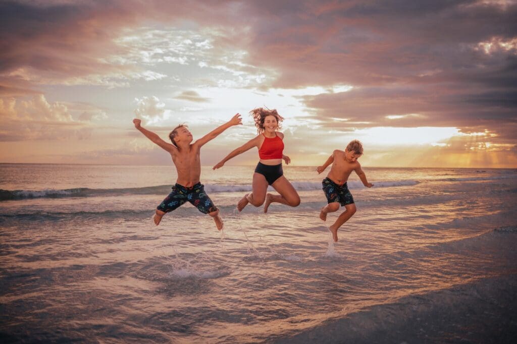 Children jumping for joy on vacation