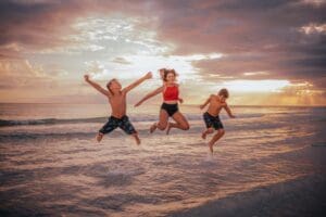 Children jumping for joy on vacation