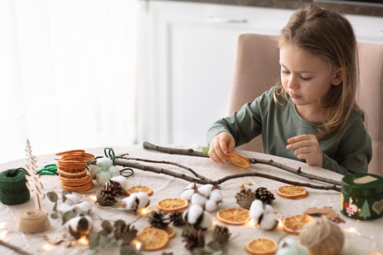 Winter holiday season. child little girl making Christmas decorations from natural minerals